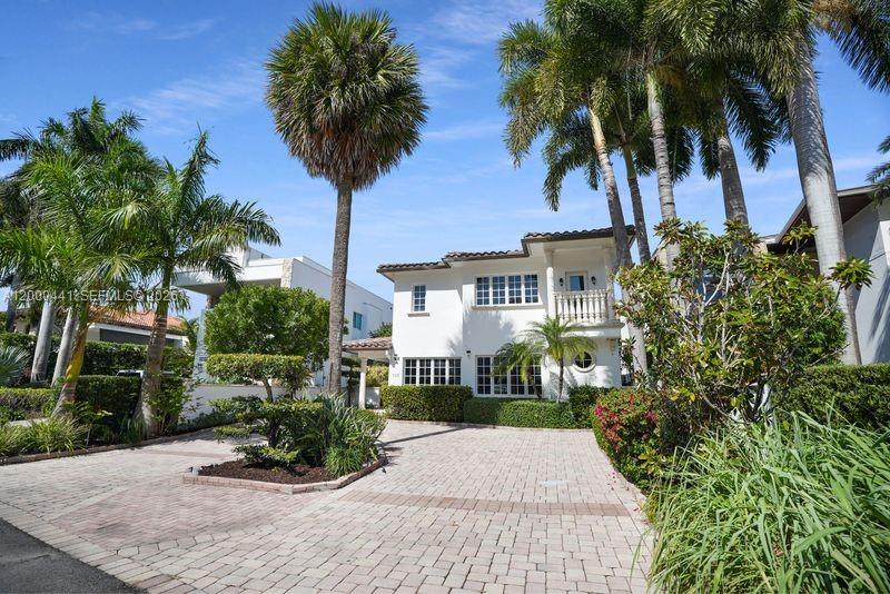 113 South Gordon Road Fort Lauderdale, FL 33301 - Photo 46 of 53 front view of a house with a yard and palm trees