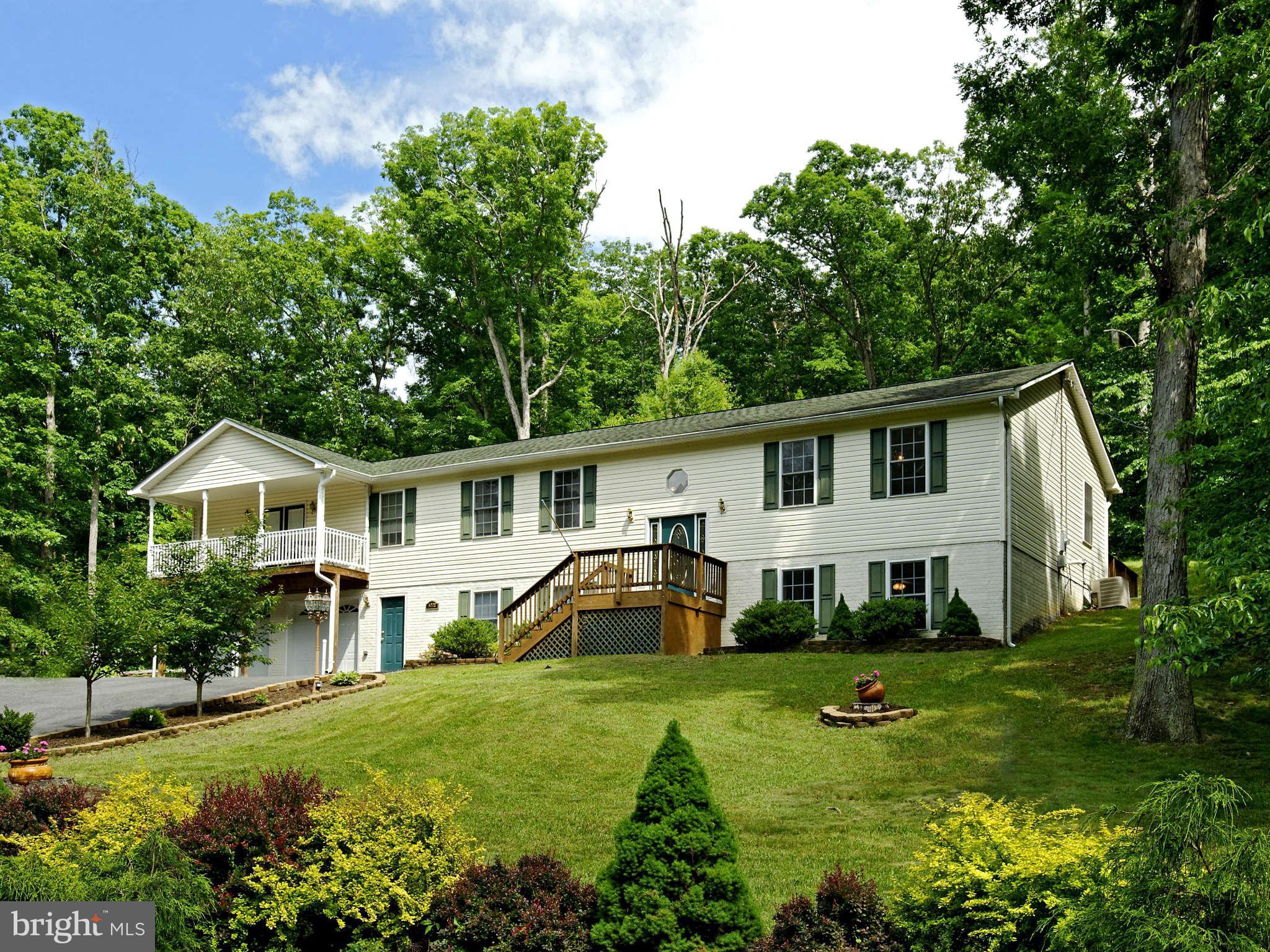 5002 Howellsville Road Front Royal, VA 22630 - Photo 1 of 21 a front view of a house with a garden