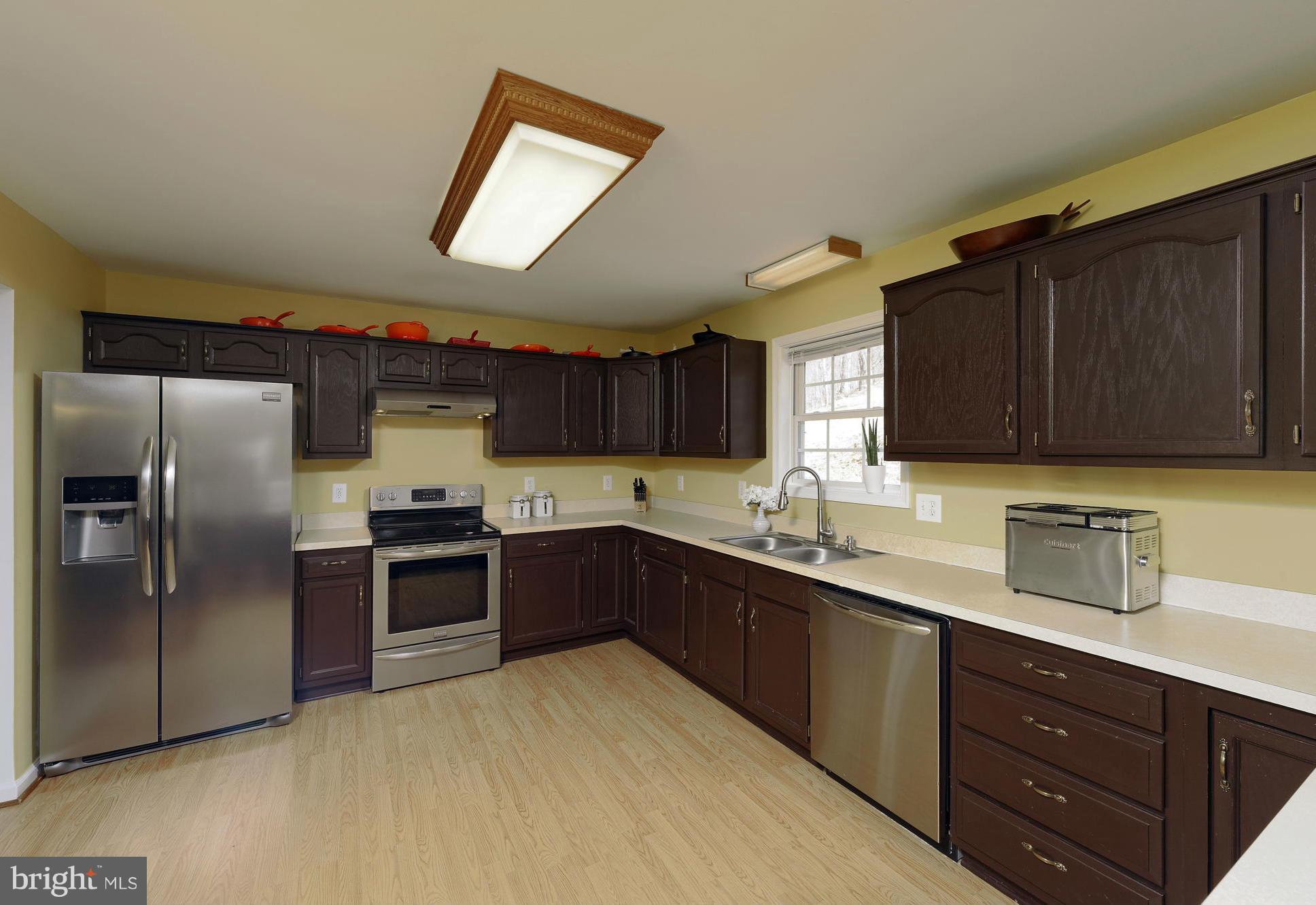 5002 Howellsville Road Front Royal, VA 22630 - Photo 2 of 21 a kitchen with stainless steel appliances granite countertop a sink a stove a refrigerator cabinets and a window