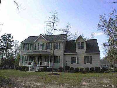 7388 Trailing Rock Road Prince George, VA 23875 - Photo 1 of 1 a front view of a house with a yard