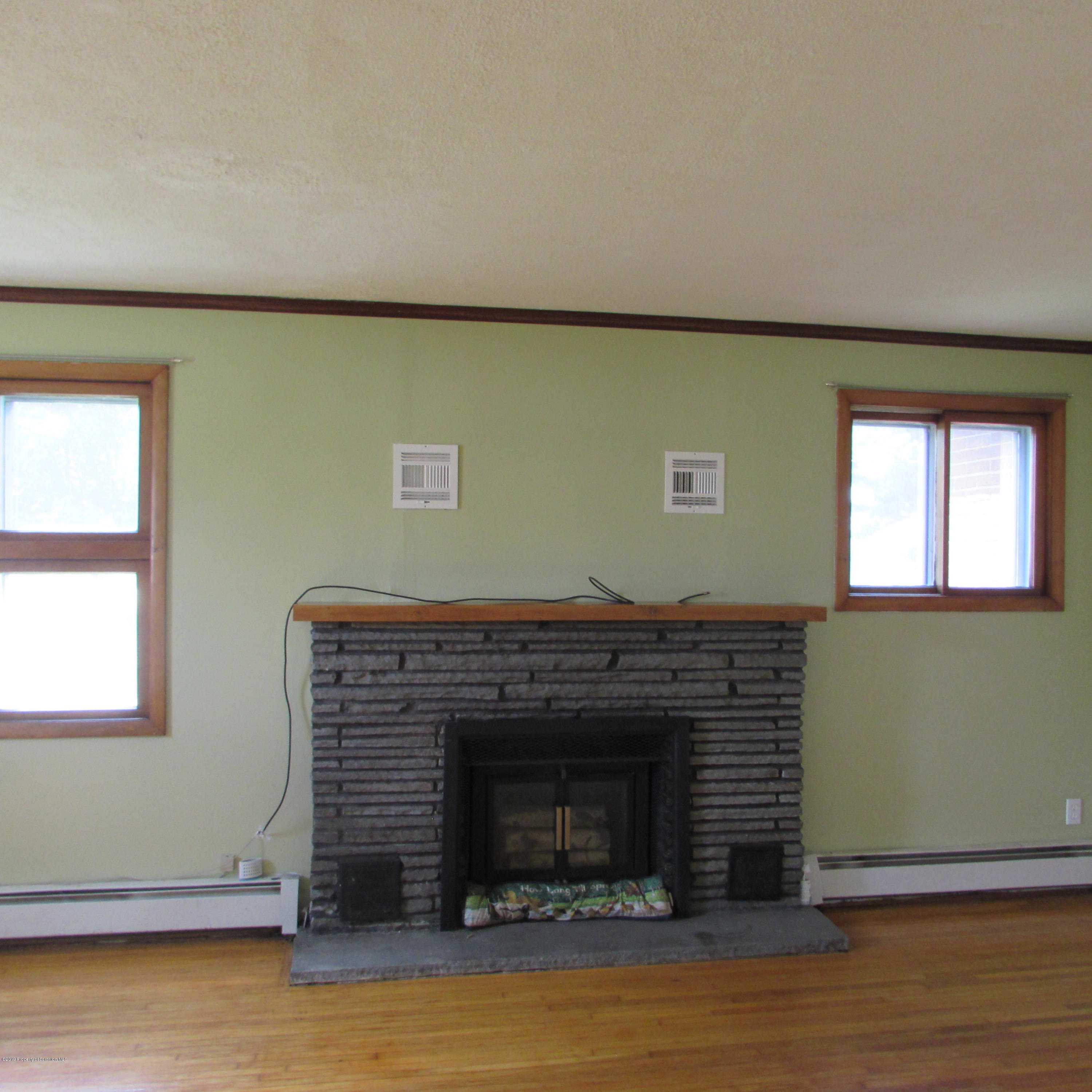 171 Sawmill Road Tunkhannock, PA 18657 - Photo 9 of 20 a view of empty room with wooden floor and fireplace