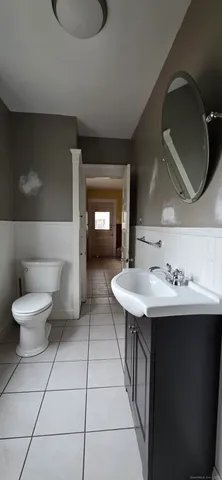 a bathroom with a sink a toilet and mirror