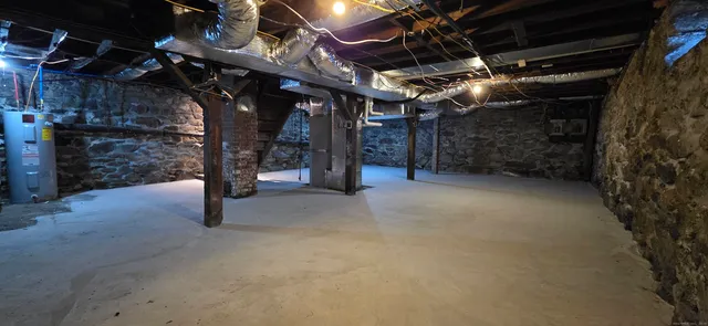 a view of water heater room with stairs