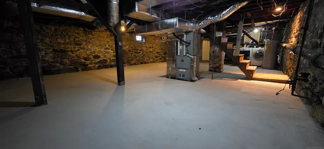 a view of water heater room with stairs