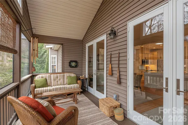a balcony with furniture and wooden floor