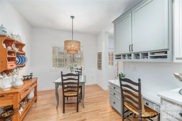 a dining room with furniture and wooden floor