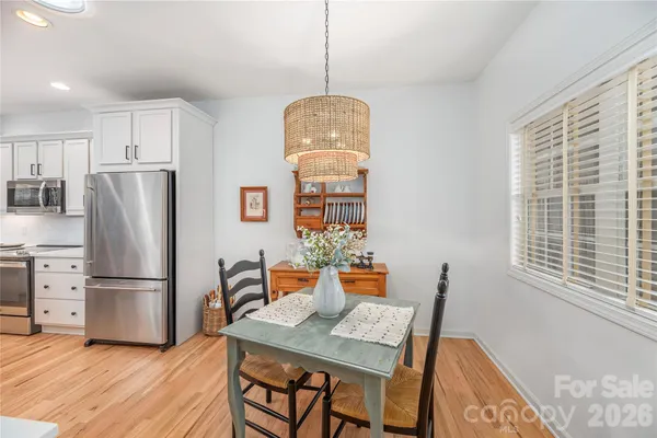 a dining room with furniture window and wooden floor