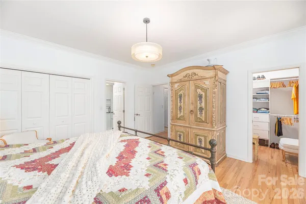 a bedroom with a bed mirror and a window