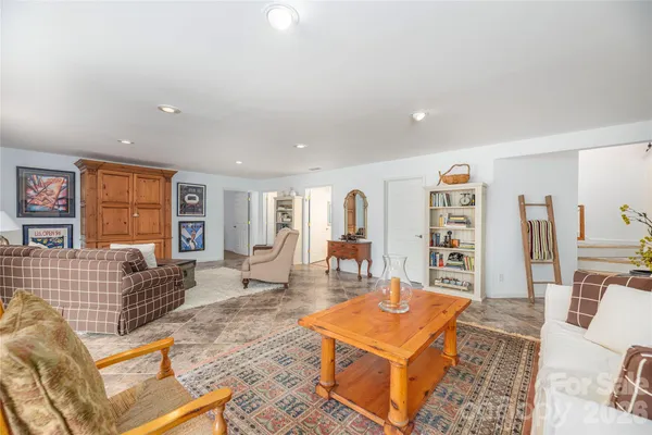 a living room with furniture a rug and a window