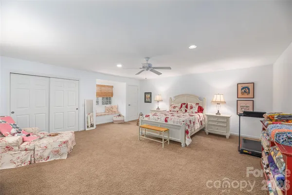 a spacious bedroom with a bed and a window