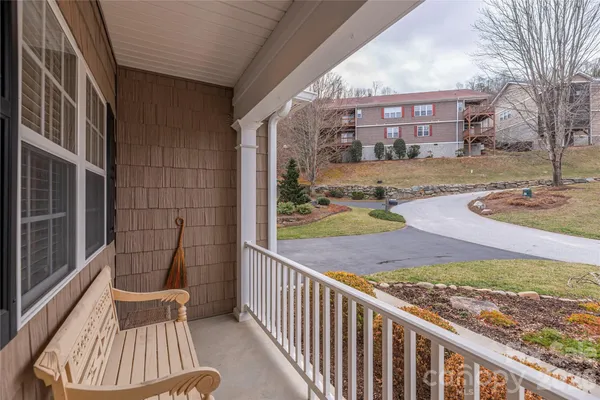a view of a chair and tables in the balcony