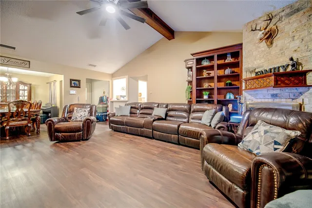 a living room with furniture and a book shelf