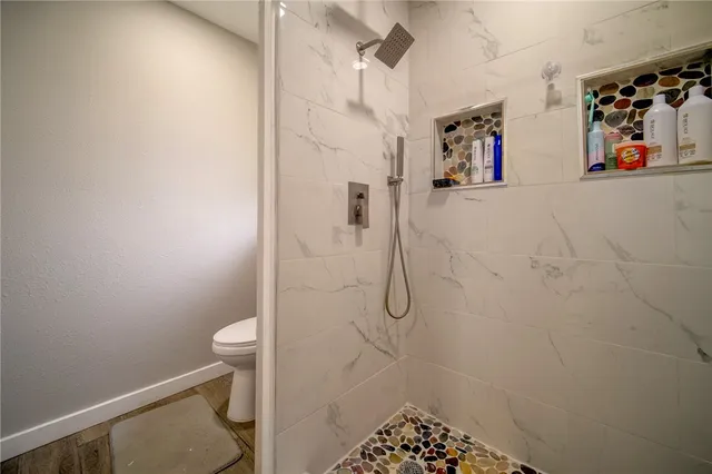 a bathroom with a shower toilet and sink
