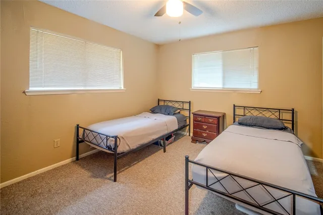 a bedroom with two beds and a window