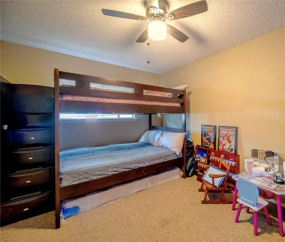 a bedroom with bed and gym equipment