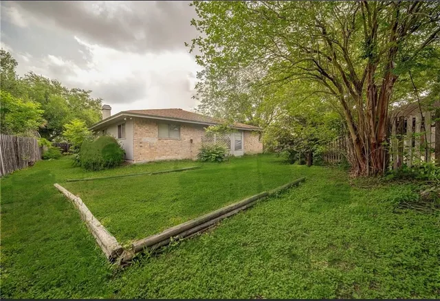 a view of a backyard with a garden and plants