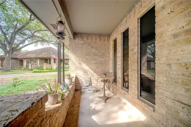 a view of a porch with chairs and backyard