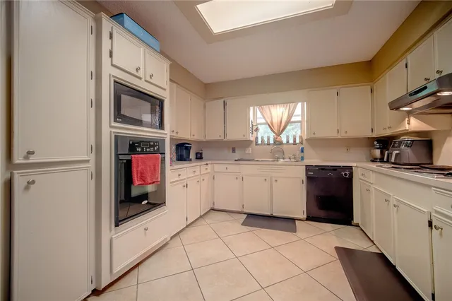 a kitchen with stainless steel appliances a sink and cabinets