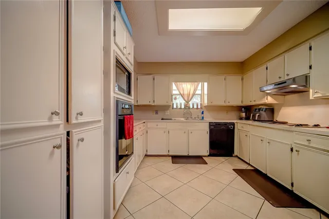 a kitchen with a sink cabinets and stainless steel appliances