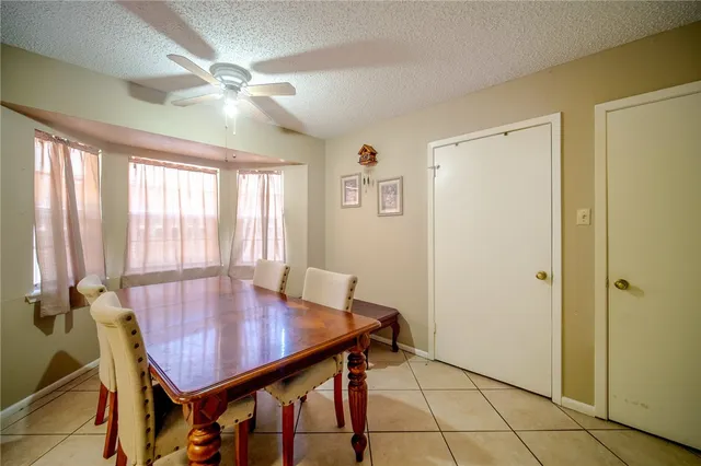 a view of a dining room with furniture and window