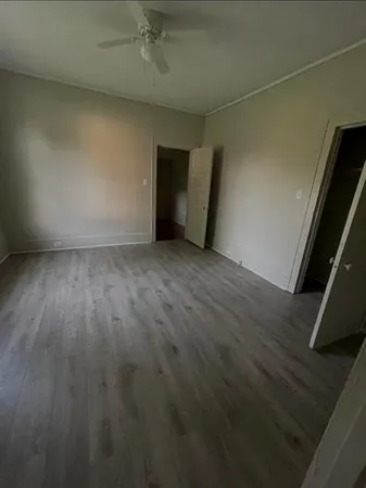 an empty room with wooden floor and closet