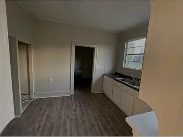 a kitchen with granite countertop a stove and a refrigerator