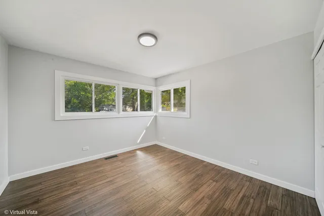 a view of a room with wooden floor and windows