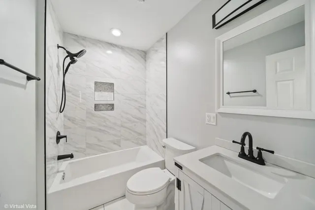 a bathroom with a sink a toilet and a bathtub