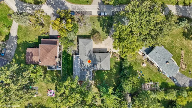 an aerial view of a house with a yard and trees