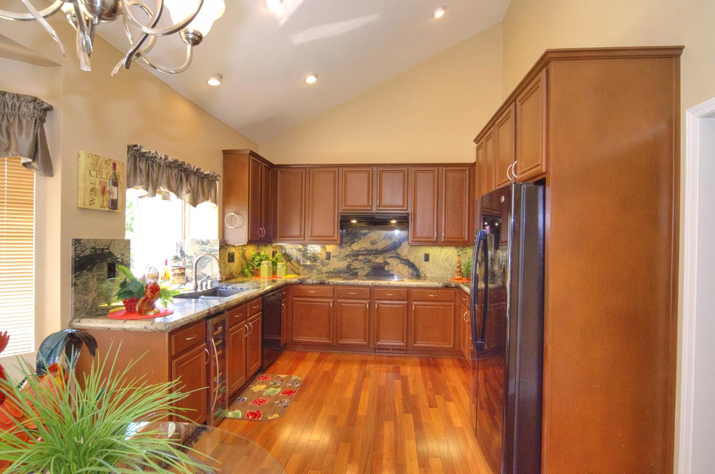 2284 Skyline Drive Milpitas, CA 95035 - Photo 8 of 35 a kitchen with stainless steel appliances granite countertop a refrigerator a sink dishwasher a stove and a dining table with wooden floor