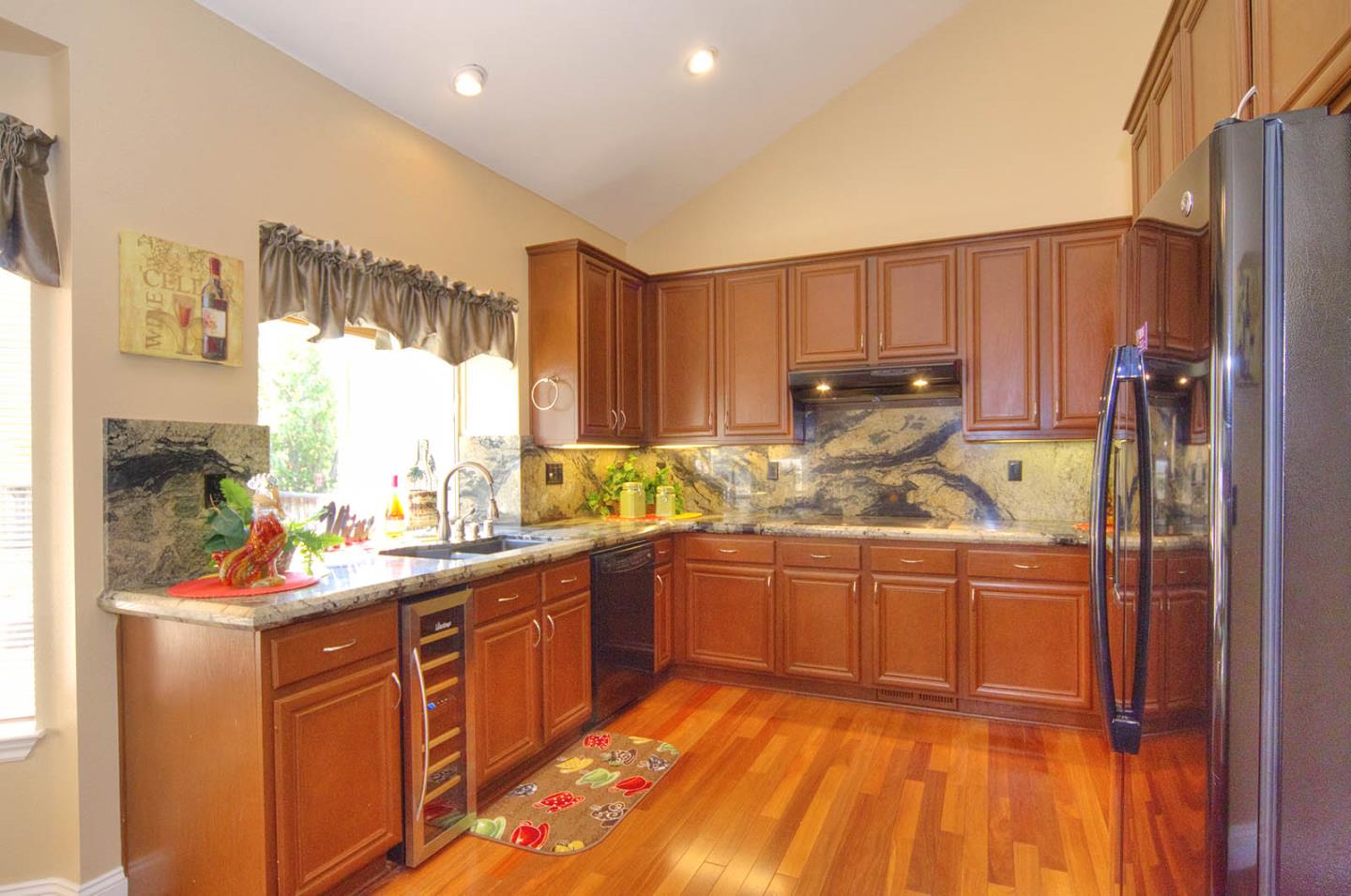2284 Skyline Drive Milpitas, CA 95035 - Photo 10 of 35 a kitchen with stainless steel appliances granite countertop a refrigerator a sink dishwasher a stove and white countertops with wooden floor