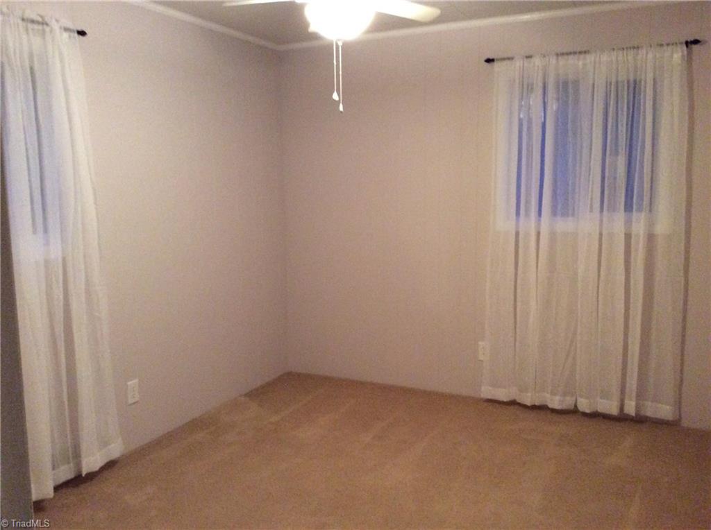 521 Cemetery Street Ronda, NC 28670 - Photo 10 of 13 Updated windows, fresh paint, reaching closet, carpet, and ceiling fan.