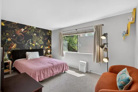 a bedroom with a bed and window