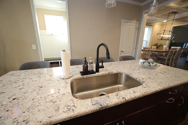a kitchen with granite countertop a sink and a stove