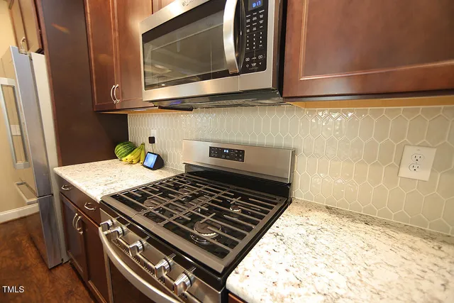 a stove top oven sitting inside of a kitchen