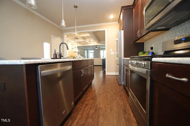 a kitchen with a sink a refrigerator and cabinets