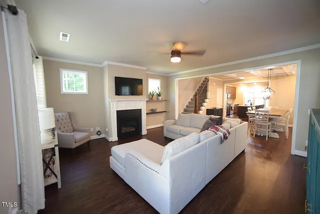 a living room with furniture fireplace and a flat screen tv