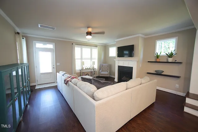 a living room with fireplace furniture and a flat screen tv