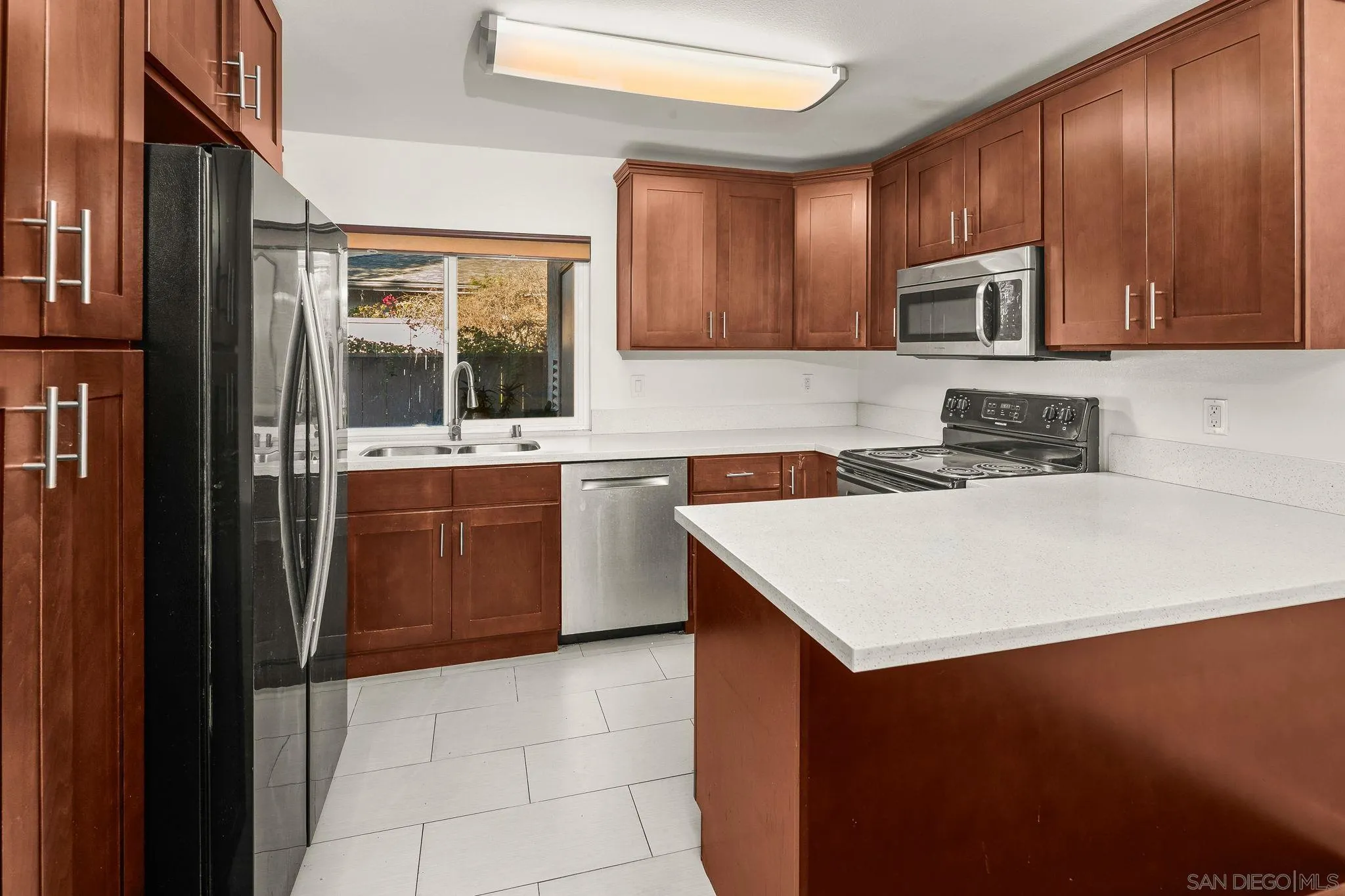 a kitchen with a sink a stove and cabinets