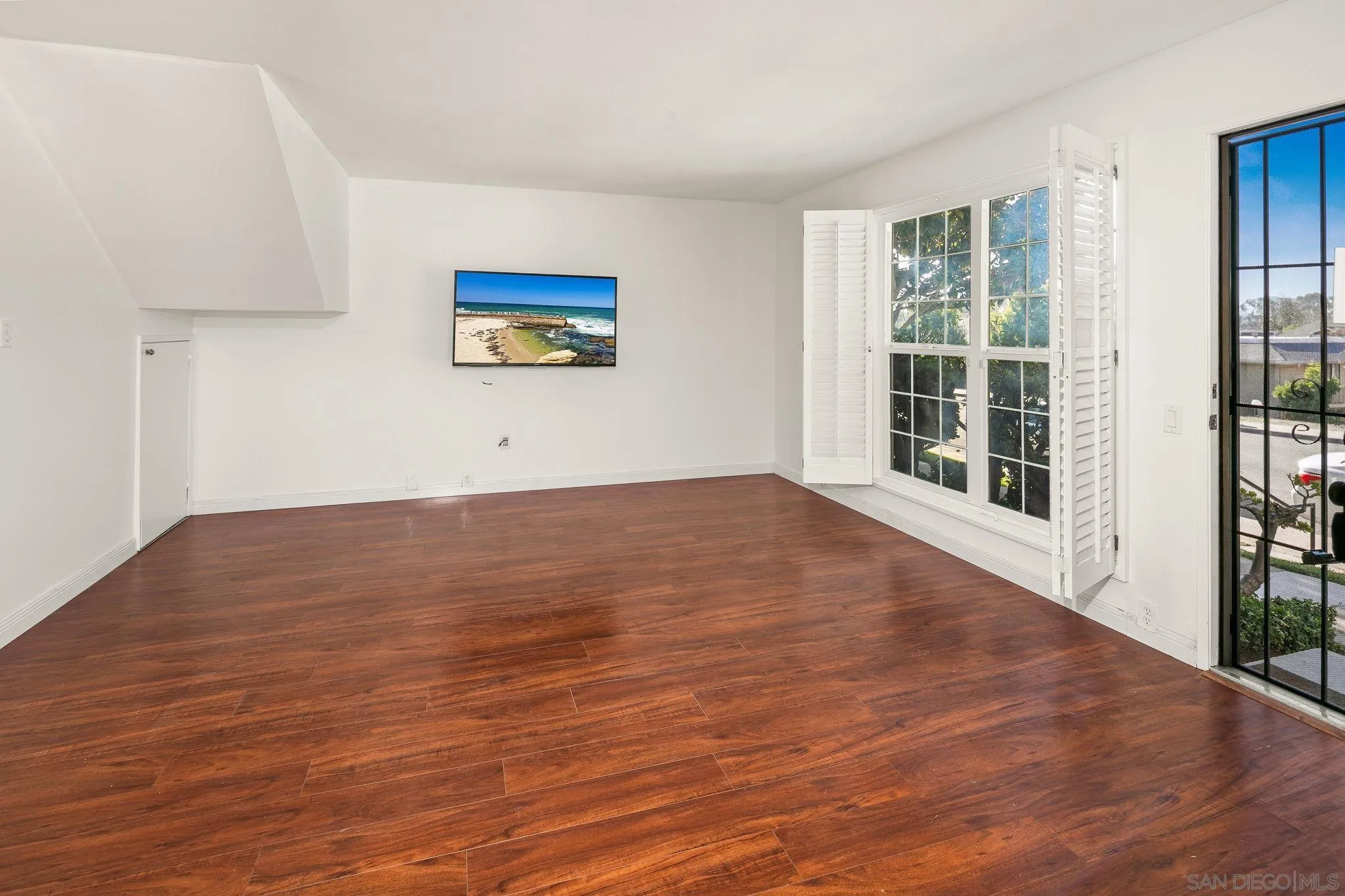 9679 Easter Way San Diego, CA 92121 - Photo 14 of 28 a view of an empty room with wooden floor and a window