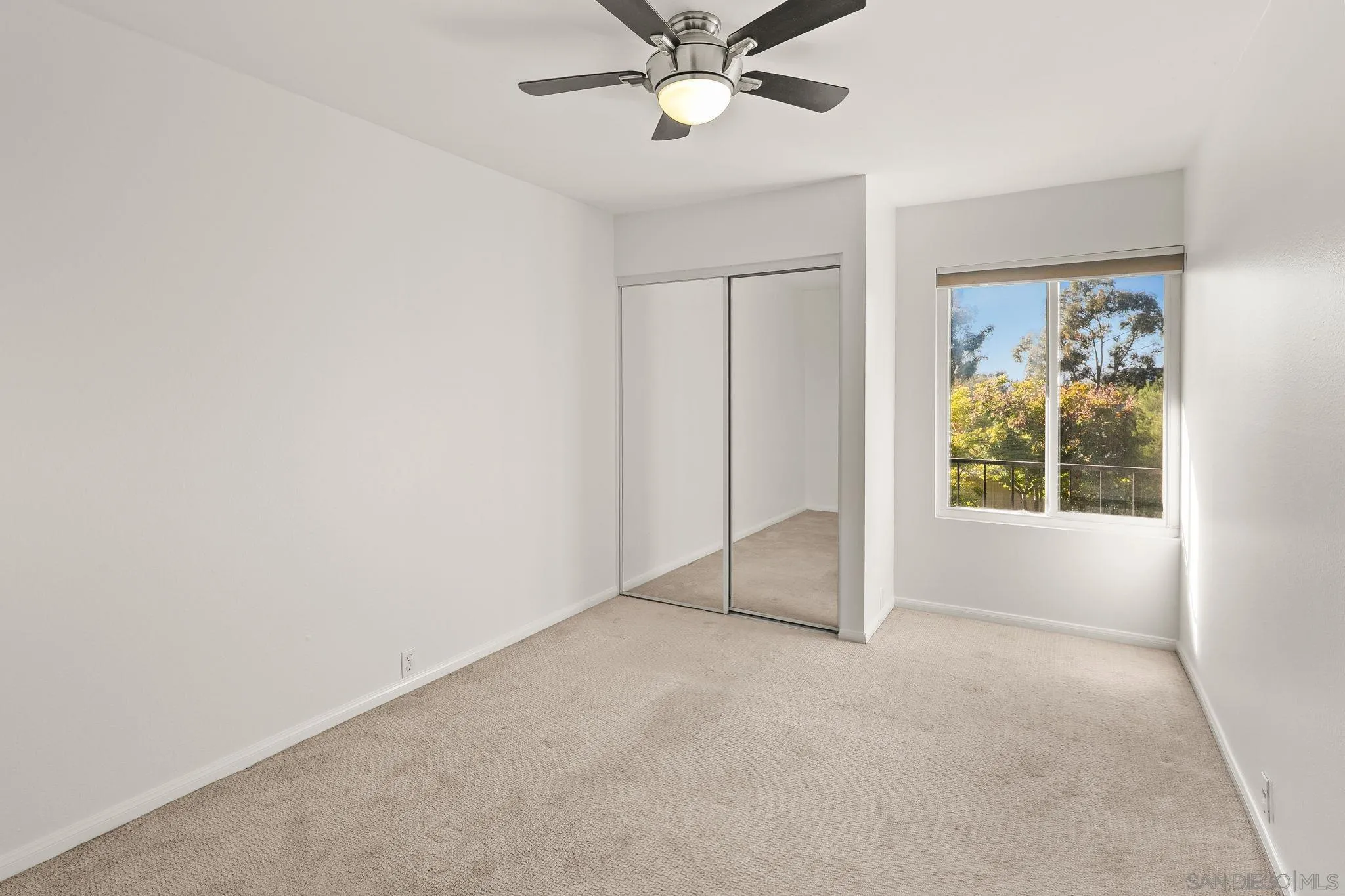 9679 Easter Way San Diego, CA 92121 - Photo 15 of 28 an empty room with ceiling fan and window
