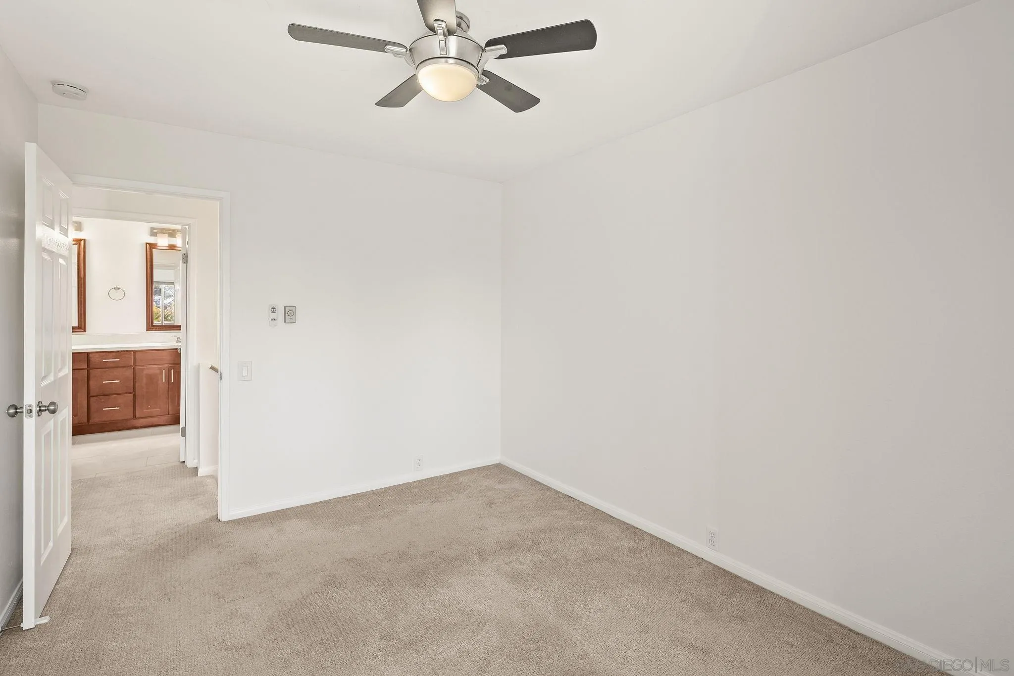 9679 Easter Way San Diego, CA 92121 - Photo 17 of 28 an empty room with a chandelier fan and windows
