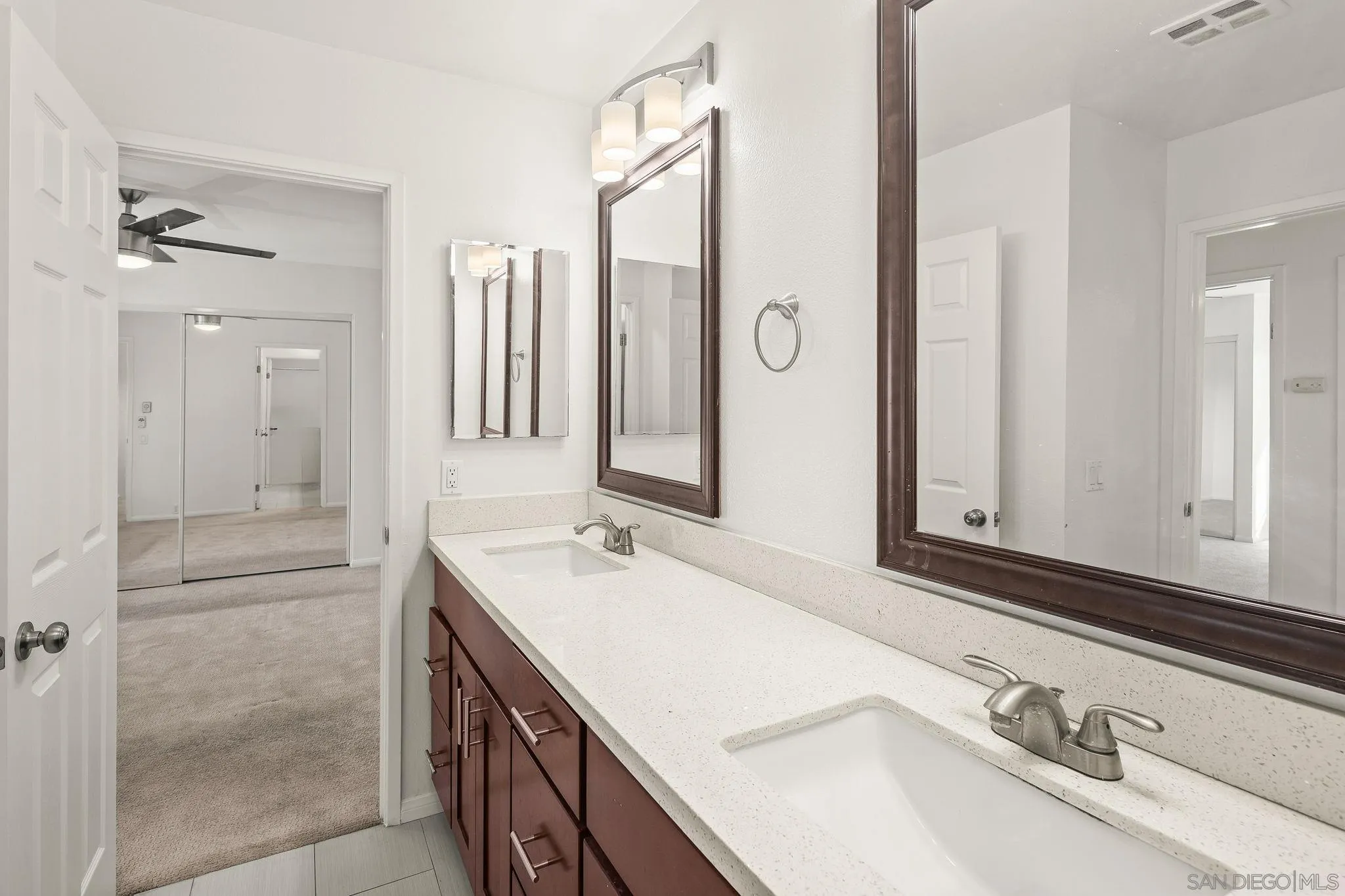 9679 Easter Way San Diego, CA 92121 - Photo 19 of 28 a bathroom with a sink double vanity and a mirror