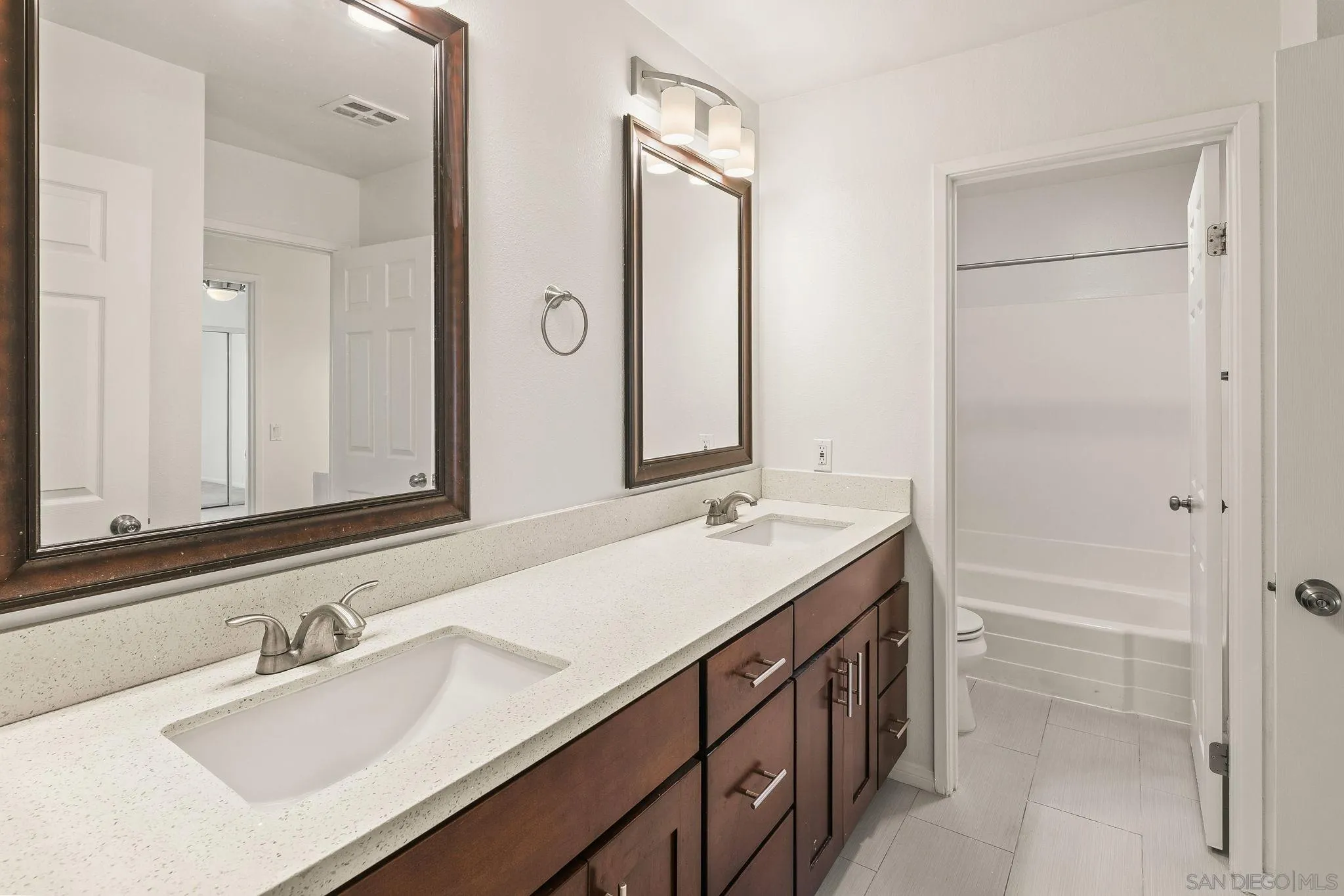 9679 Easter Way San Diego, CA 92121 - Photo 20 of 28 a bathroom with a sink double vanity and a mirror