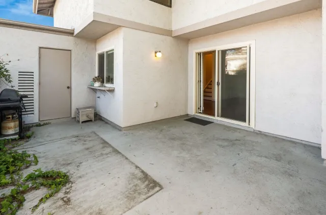 an empty room with a ceiling fan and carpet