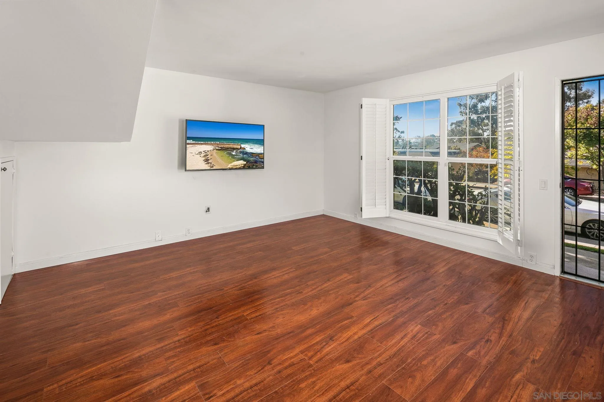 9679 Easter Way San Diego, CA 92121 - Photo 4 of 28 a view of an empty room with wooden floor and a window