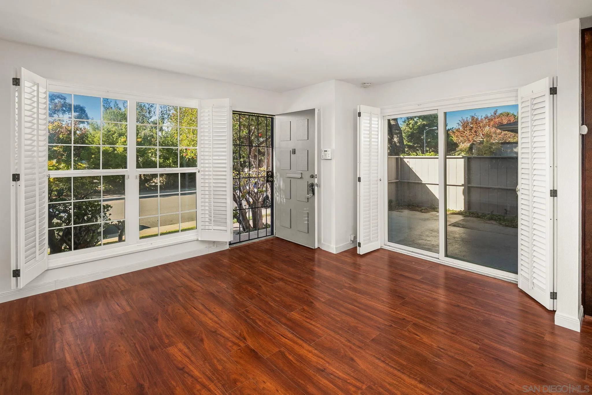 9679 Easter Way San Diego, CA 92121 - Photo 10 of 28 a view of an empty room with wooden floor and a window