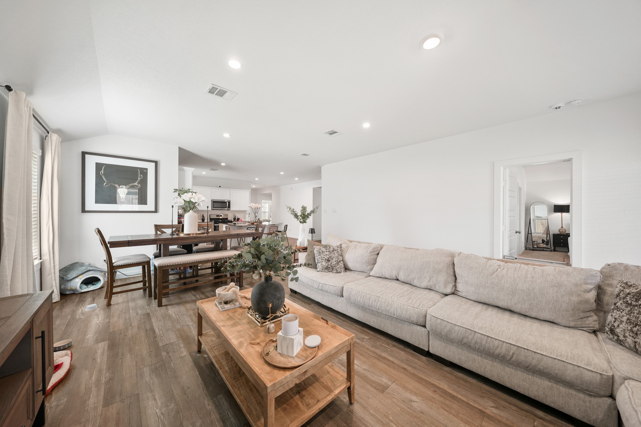 8918 Century Plant Lane Rosharon, TX 77583 - Photo 12 of 19 Spacious open-concept living and dining area with recessed lighting, wood-look flooring, and direct connection to the kitchen.