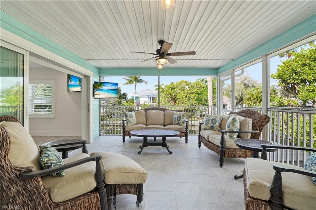 270 Dundee Road Fort Myers Beach, FL 33931 - Photo 35 of 48 Sunroom / solarium featuring an outdoor hangout area and a ceiling fan - Virtually Edited Image