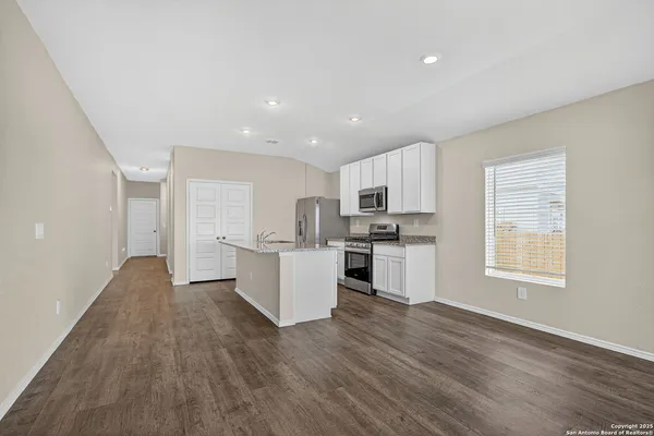 a view of kitchen with wooden floor and electronic appliances